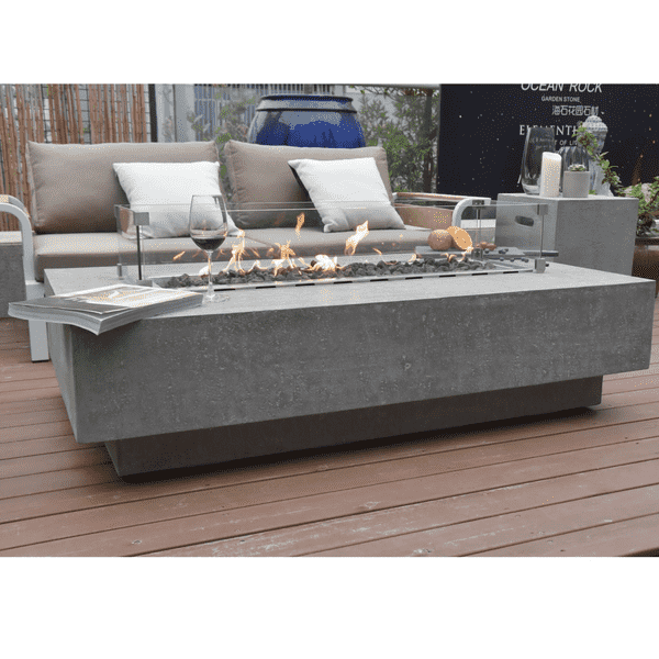 Elementi Hampton Rectangle Concrete Fire Pit Table With Wine And A Book On The Corner Front View On A Deck