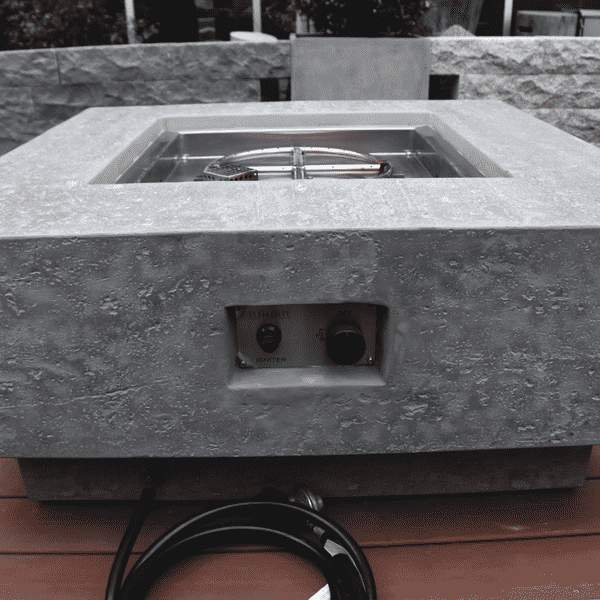 Elementi Manhattan Square Concrete Fire Pit Table OFG103 Side View without Flame, visible Ignition System Control Knob and Propane Hose and Regulator Connection