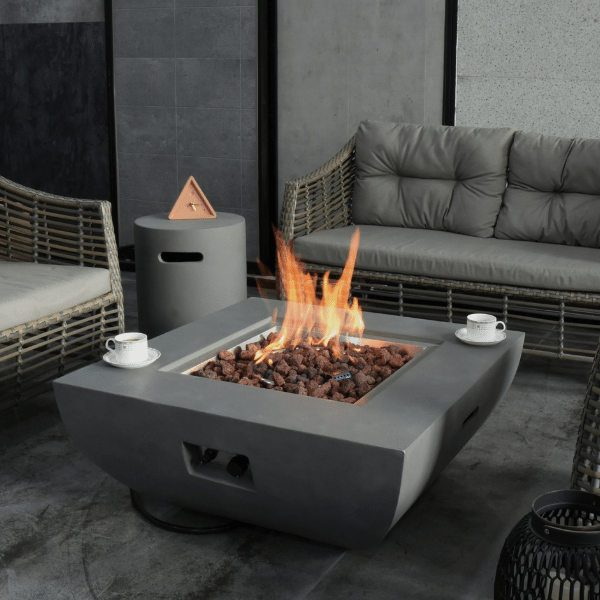 Modeno Westport Square Concrete Fire Pit Table OFG135 WIth Flame Tea Cups and Propane Tank Cover on a Covered Patio Backyard Set Up