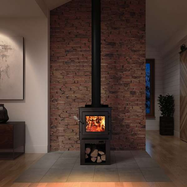 Drolet Deco Nano Wood Stove Infront Of A Brick Wall With Flame On And Logs Underneath