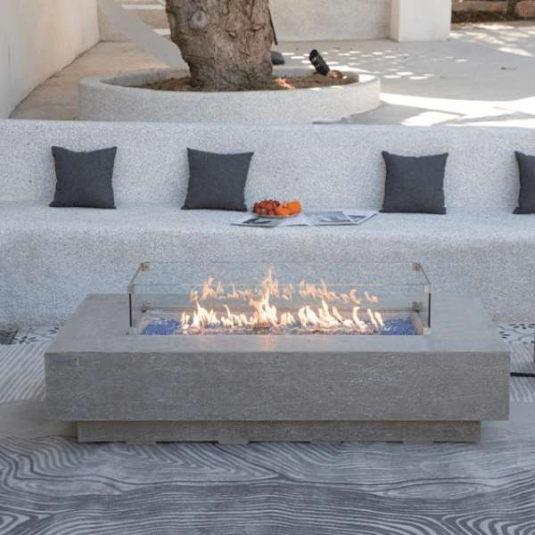 Elementi Plus Riviera Fire Table OFG415LG With Flames and Windscreen in Backyard Set Up