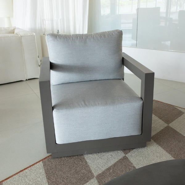 Gray armchair with cushion in a modern living room setting