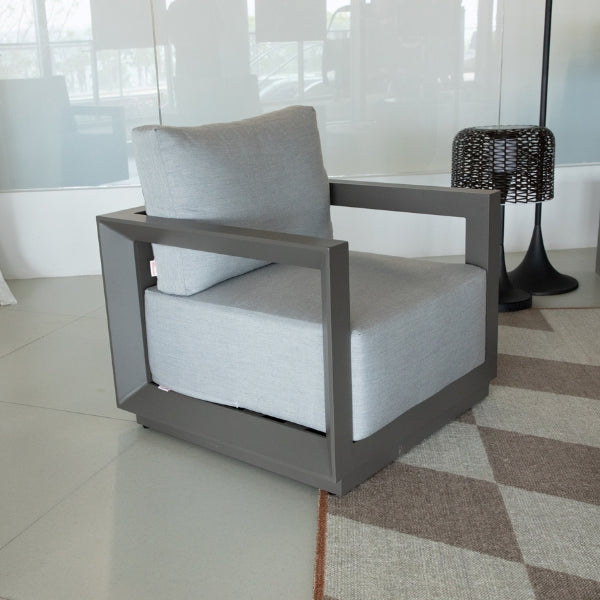 Gray armchair with a cushion in a modern interior setting