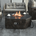 Elementi Columbia Hexagon Concrete Fire Pit Table OFG105 With Flame, Propane Tank Cover and Coffee Cups sitting on top
