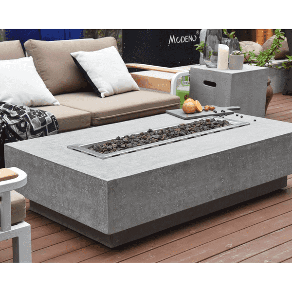 Elementi Hampton Rectangle Concrete Fire Pit Table Without Flame Side View On A Deck With Couches, Fruit And A Tank Cover