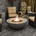 Elementi Lunar Round Concrete Fire Pit Table OFG101 Actual Photo with Flame and Round Tank Cover on Background on a Covered Patio Set Up