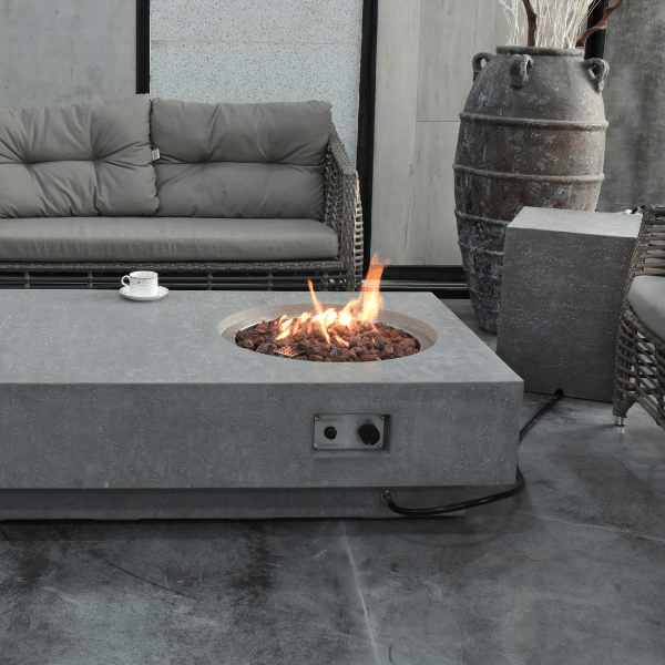 Elementi Metropolis Rectangle Concrete Fire Pit Table OFG104 With Flame, Propane Tank Cover, Wine, Fruits, Spacious Coffee Table, Couch on Covered Patio Set Up