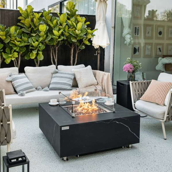 Elementi Plus Sofia Marble Porcelain Fire Table OFP103BB In Backyard With Flames and Propane Tank Cover