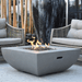 Modeno Westport Square Concrete Fire Pit Table OFG135 With Flame On Backyard Set Up