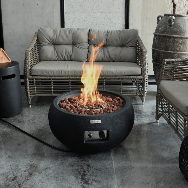 Modeno York Round Concrete Fire Bowl OFG115 With Flame Propane Tank Cover With Couch and Accent Chairs on Background