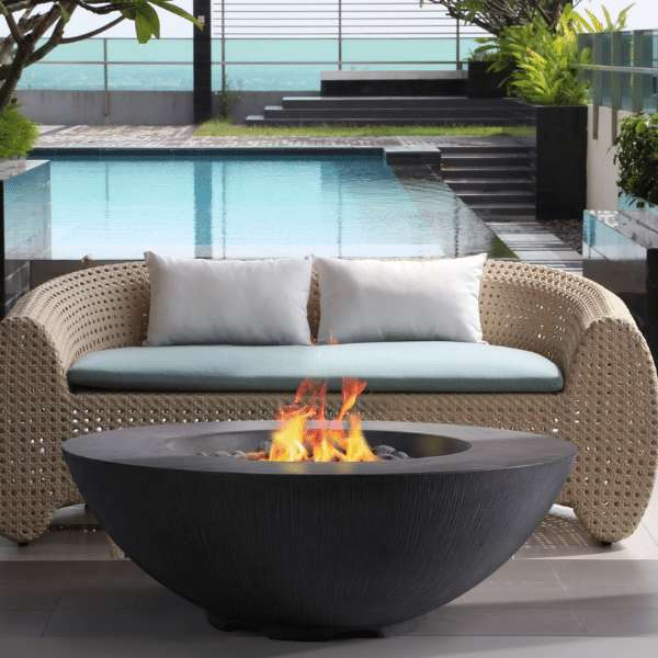 PyroMania Fire Shangri-La Round Concrete Fire Pit Table Charcoal with Flame On a Resort Set Up