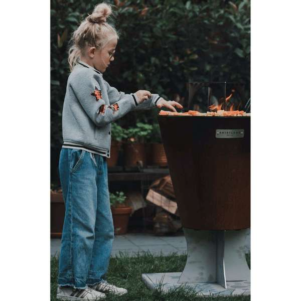 A Child Grilling Veggies On The Arteflame Black Label One Series Grill On A Backyard Set Up