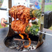 Arteflame Rotisserie With Grilled Meat On It On Top Of The Arteflame Grill