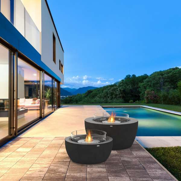     Ecosmart Fire Pod 40 Freestanding Fire Pit With Flame On And Windscreen In Graphite Beside A Pool On An Outdoor Set Up