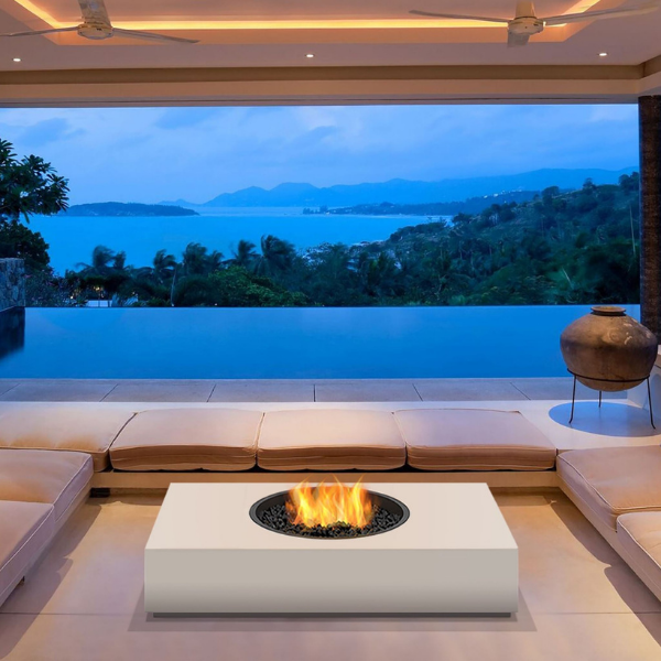 Ecosmart Martini 50 Fire Pit Table In Bone With Flame In Between The Couches On A Pool Area
