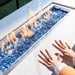 Elementi Plus Carrara Marble Pocelain Fire Table OFP121BW With Flames on Blue Fire Glass