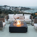 Elementi Plus Roraima Fire Table OFG411SL  With Flames Windscreen On A Backyard Set-Up