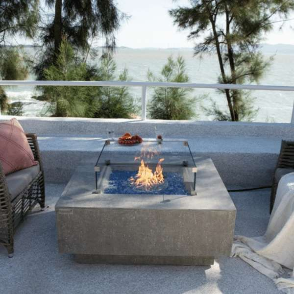 Elementi Plus Victoria Fire Table OFG413LG With Flames and Windscreen In Backyard Set Up