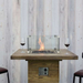 Elementi Rova Bar Table With Flame On And A Windscreen With Wine Glasses On The Sides