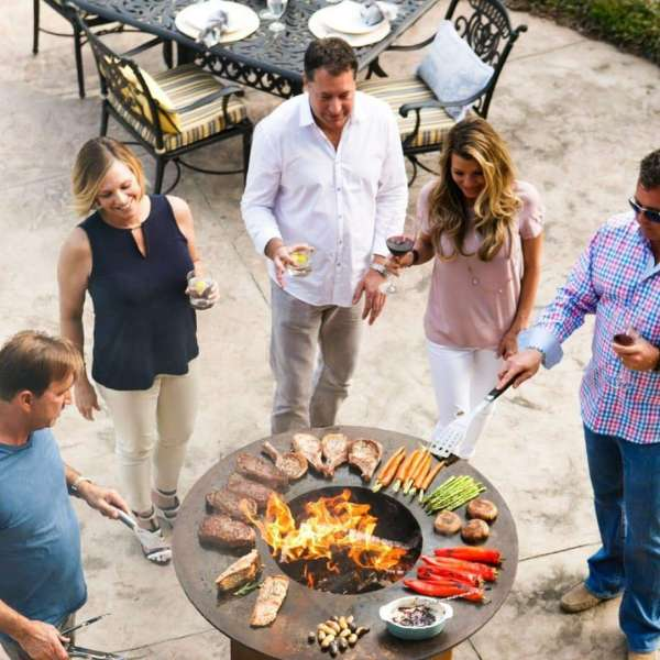 Friends Partying And Grilling With The Arteflame Classic 40 Inch Black Label Grill Tall Round Base With Storage