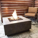 Prism Hardscapes Tavola 42 Concrete Gas Fire Pit Ph 427 In Pewter With Flame On A Backyard With Chair On The Side