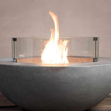 Starfire Designs Beton Round Glass Wind Guard On A Beton Round Fire Pit With Flame On