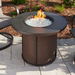 The Outdoor Greatroom Brown Stonefire Round Gas Fire Pit Table On An Outdoor Set Up