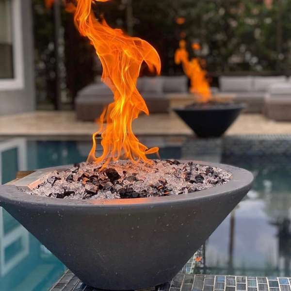    The Outdoor Plus Cazo Concrete Fire Bowl In An Outdoor Swimming Pool Set Up
