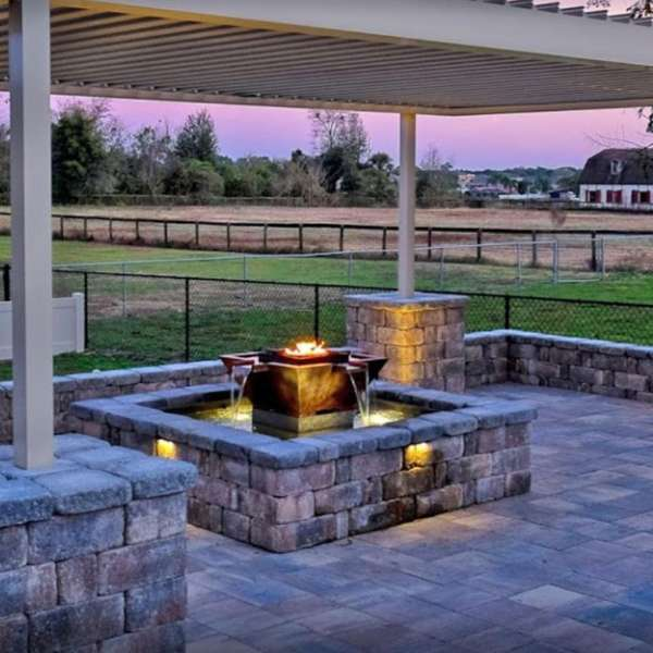     The Outdoor Plus Olympian Square 4 Way Copper Fire Water Fountain In An Outdoor Set Up